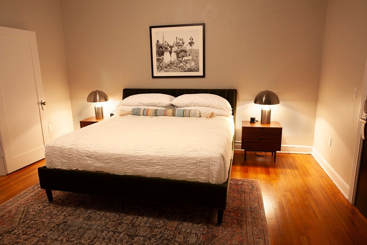 A bedroom with a king size bed and two nightstands