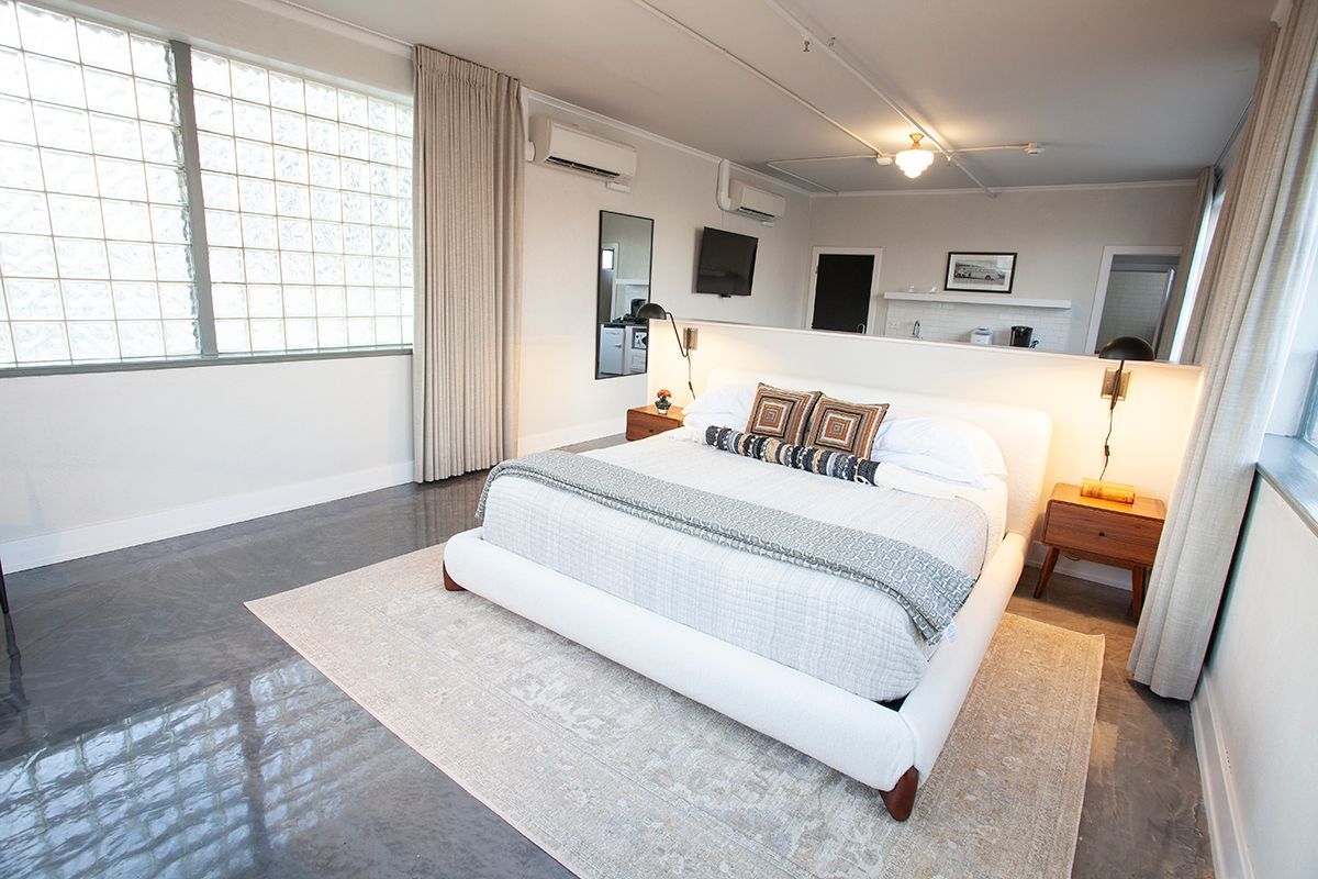 A bedroom with a large bed and a large window