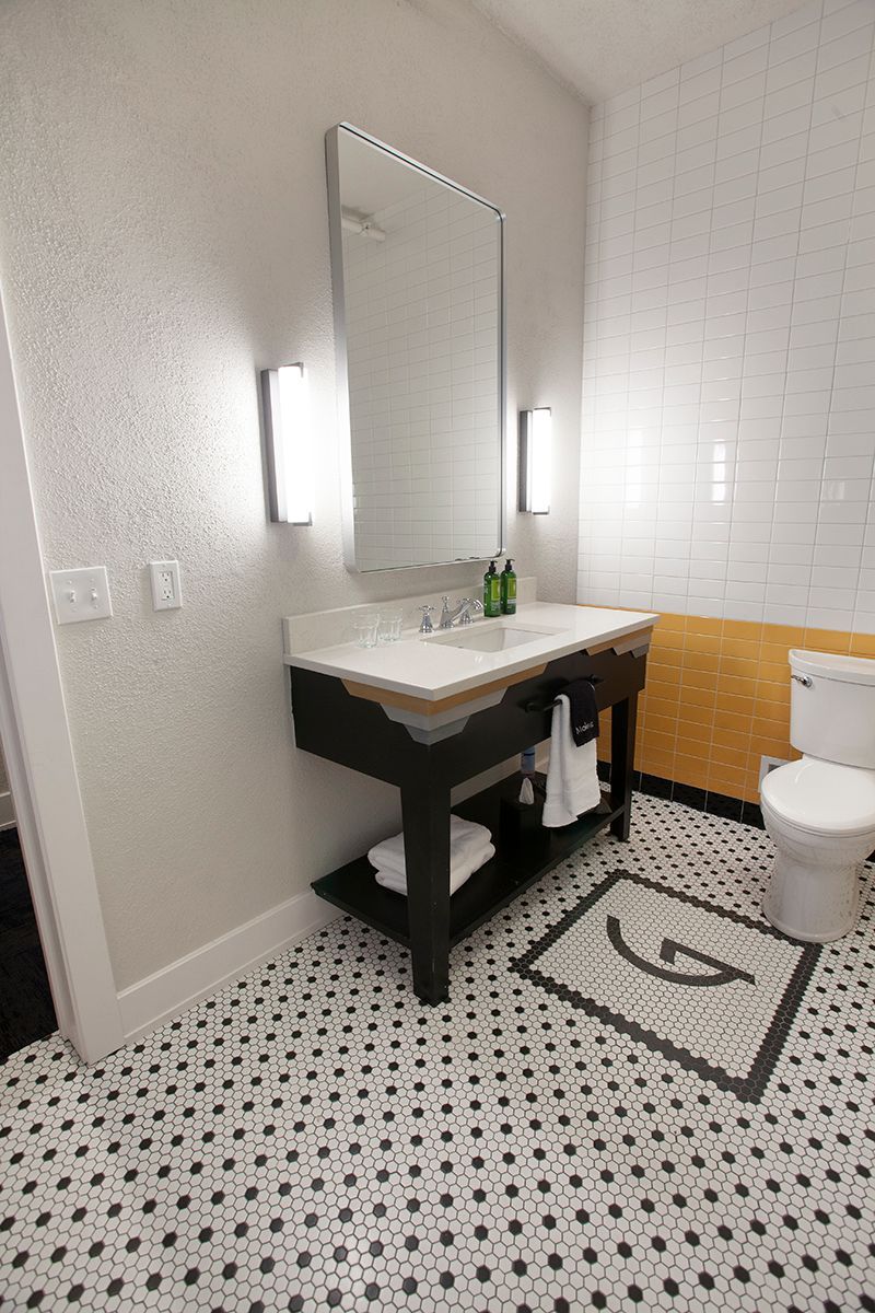 A bathroom with a sink , toilet and mirror.