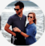 a man and a woman are standing next to each other on the beach .