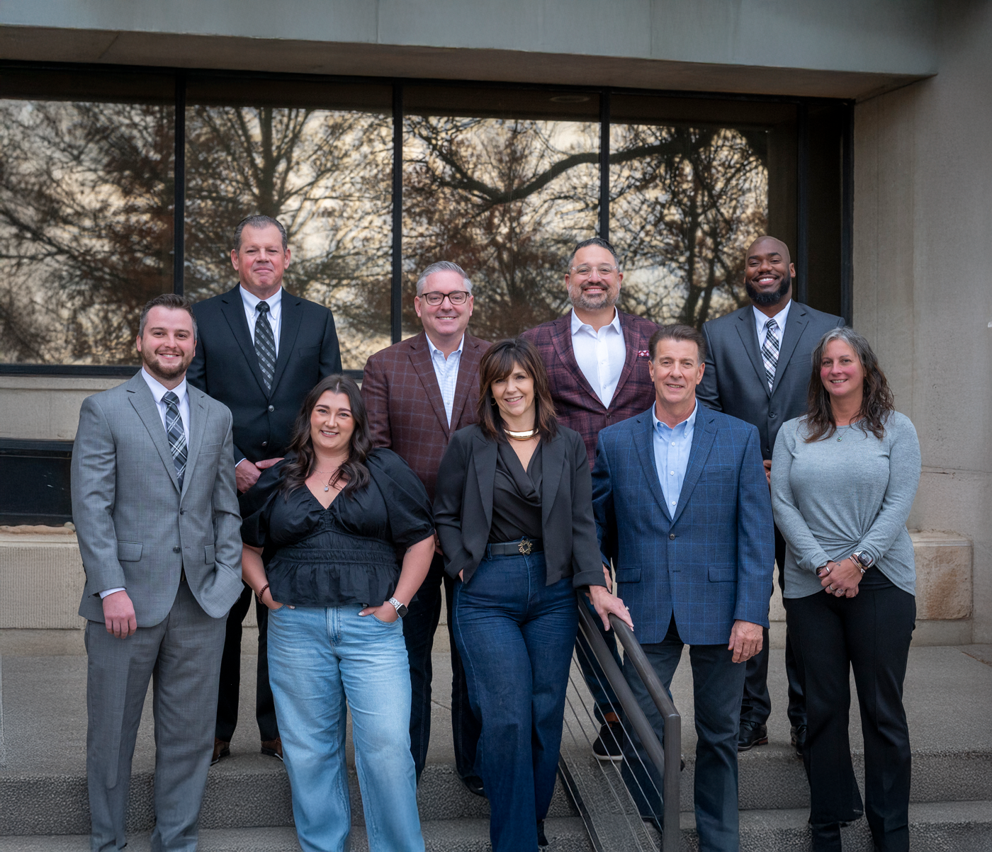 sales team photo outside of office building