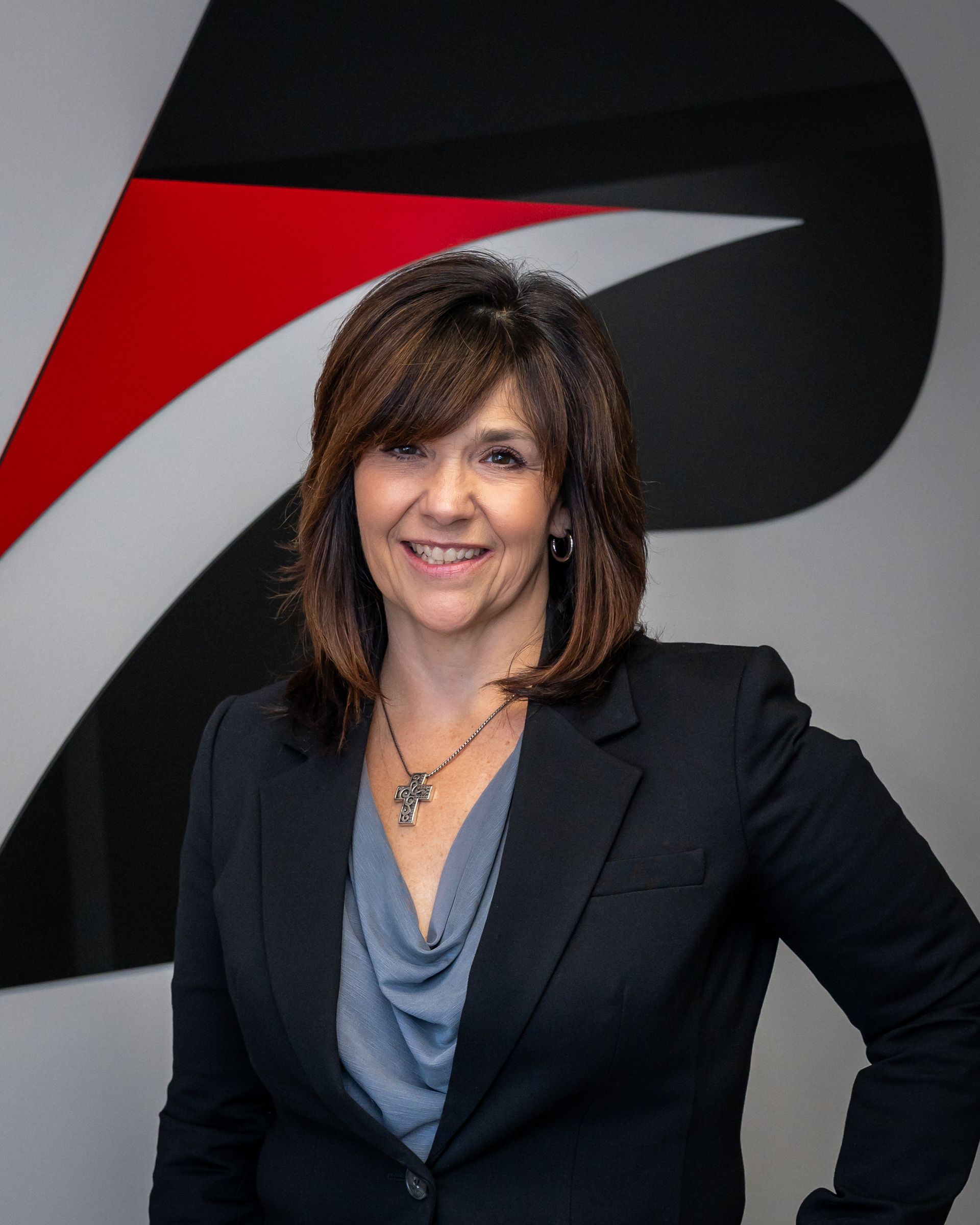 Co-Owner Lynn Pickford in front of the Precision Copy sign