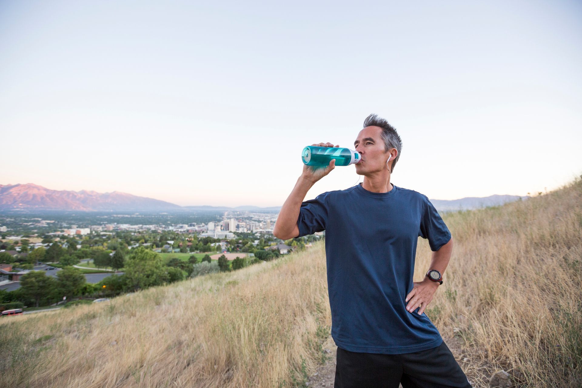 Men drinking water in a field | Portraying Men Testosterone Therapy serving Carmel, IN Men drinking water in a field | Portraying Men Testosterone Therapy serving Carmel, IN