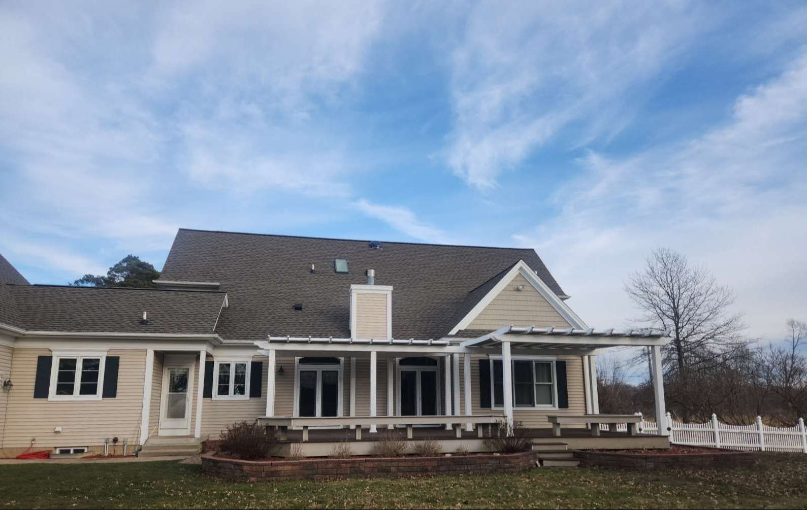 A large house with a gray roof and a porch
