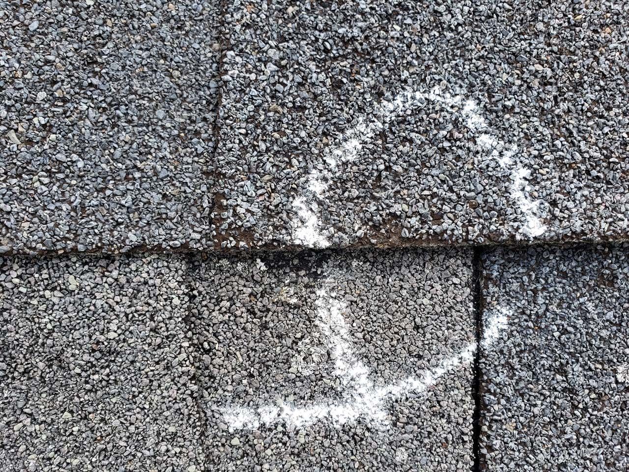 A close up of a roof with a smiley face drawn on it.