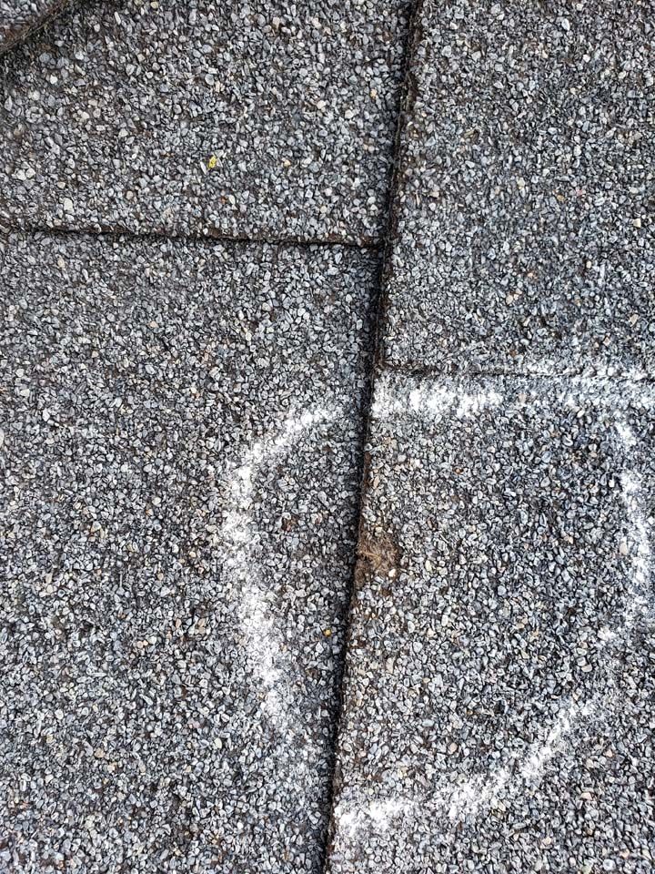 A close up of a concrete surface with a heart drawn on it.