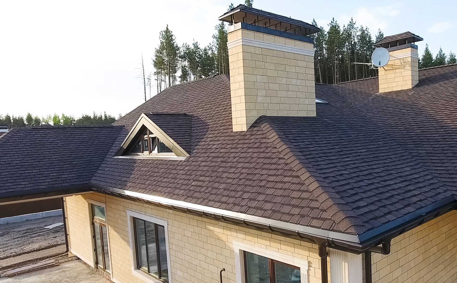 An aerial view of a house with a roof and chimneys.