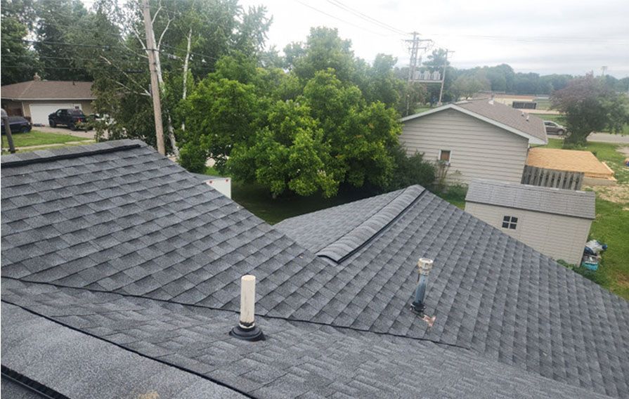 A roof of a house with a chimney on top of it.