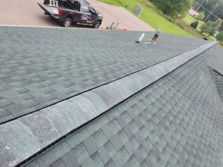A truck is parked on the roof of a house.