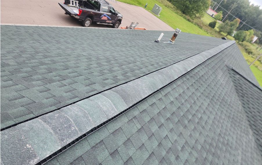 A truck is parked on the roof of a house.