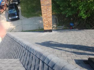 A roof with a chimney and a car parked on the side of it.