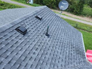 A roof with a satellite dish on top of it.