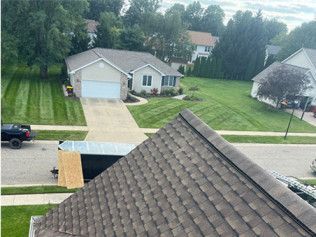 An aerial view of a house with a truck parked in front of it.