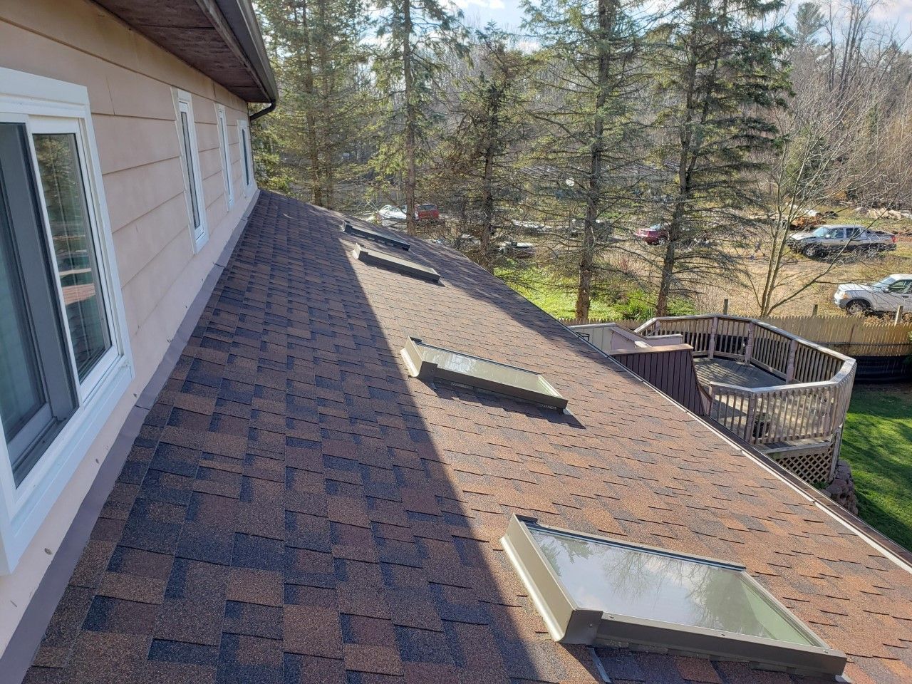 A house with a roof that has a lot of windows and skylights on it.