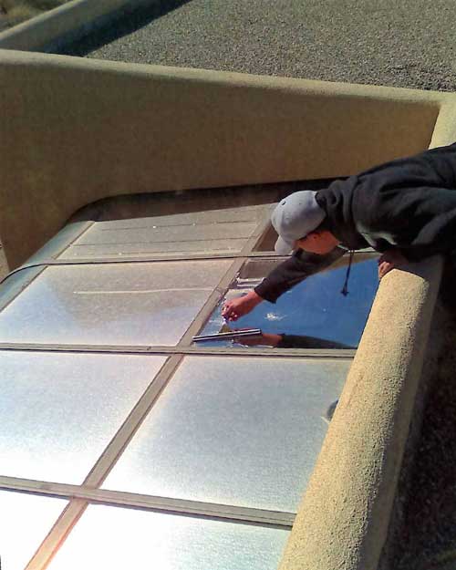 Man at top of roof window washing - Residential and Commercial Window Cleaning