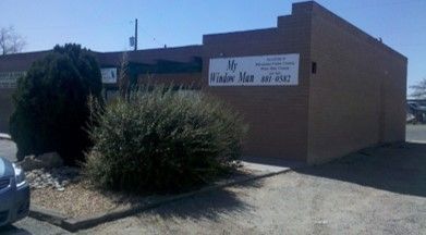 A brick building with a sign on the side.