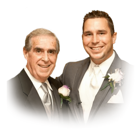 Two men in suits standing, smiling