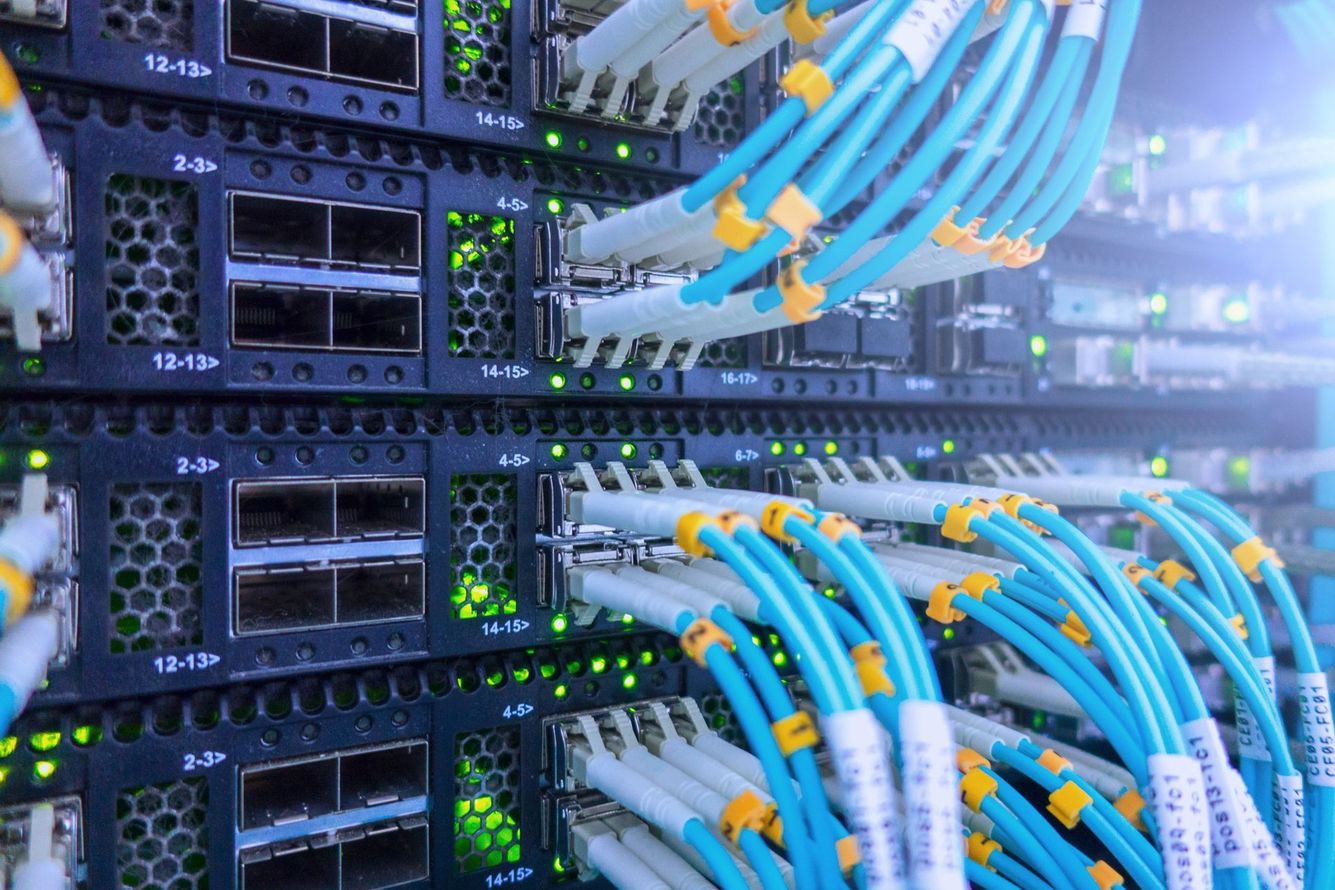 A bunch of wires are connected to a server in a data center