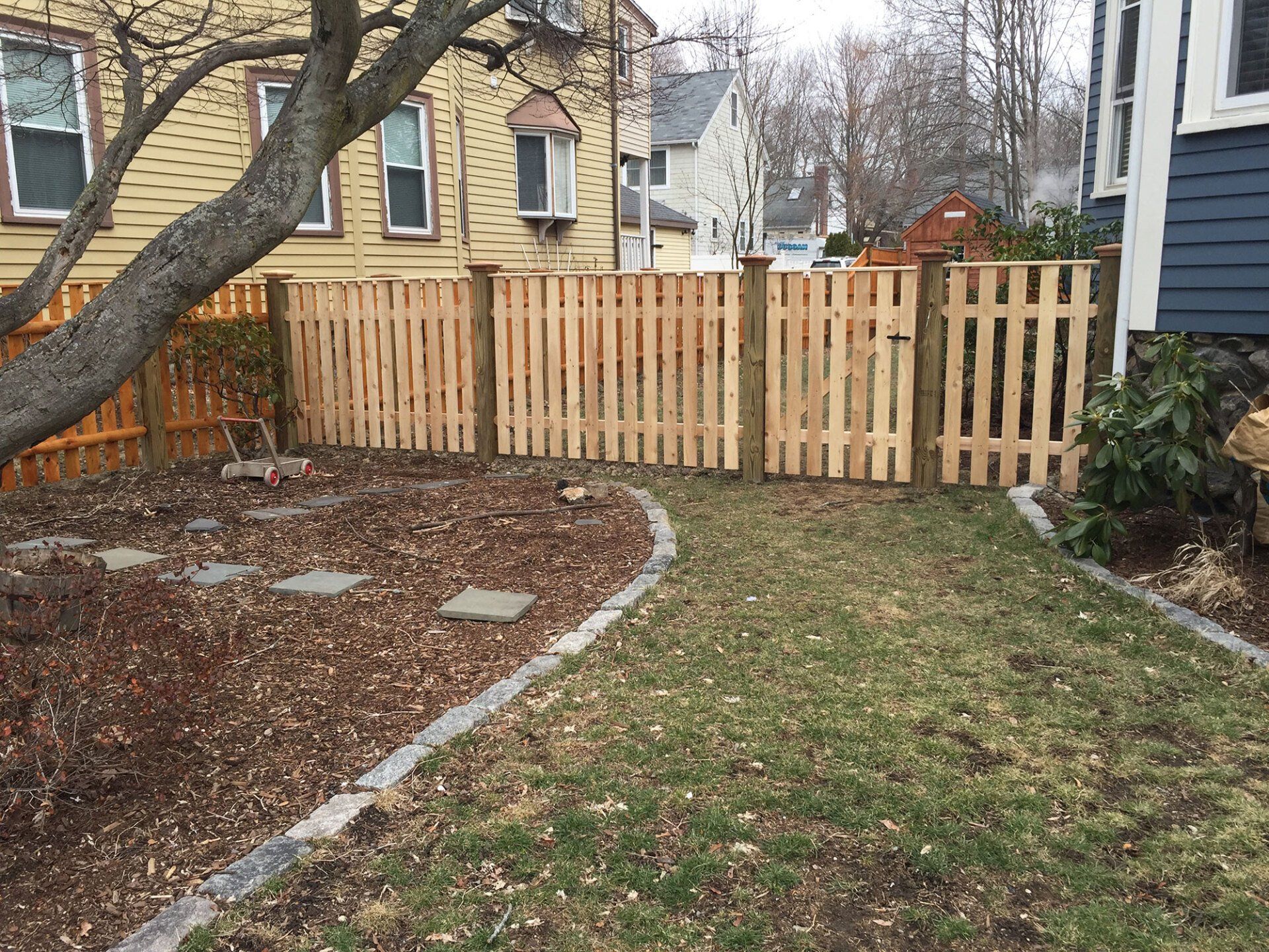 Spaced board with cap strip and pressure treated posts