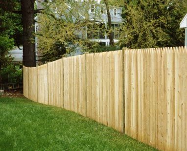 Stockade with round pressure-treated posts