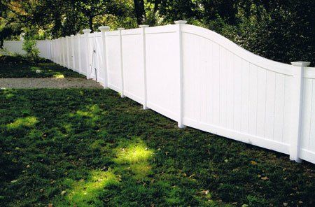 Vinyl six-foot privacy with s-slope to four-foot high