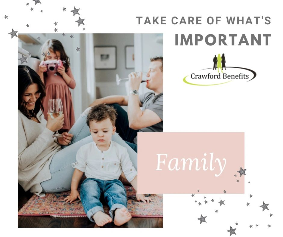 A family is sitting on the floor in a living room.