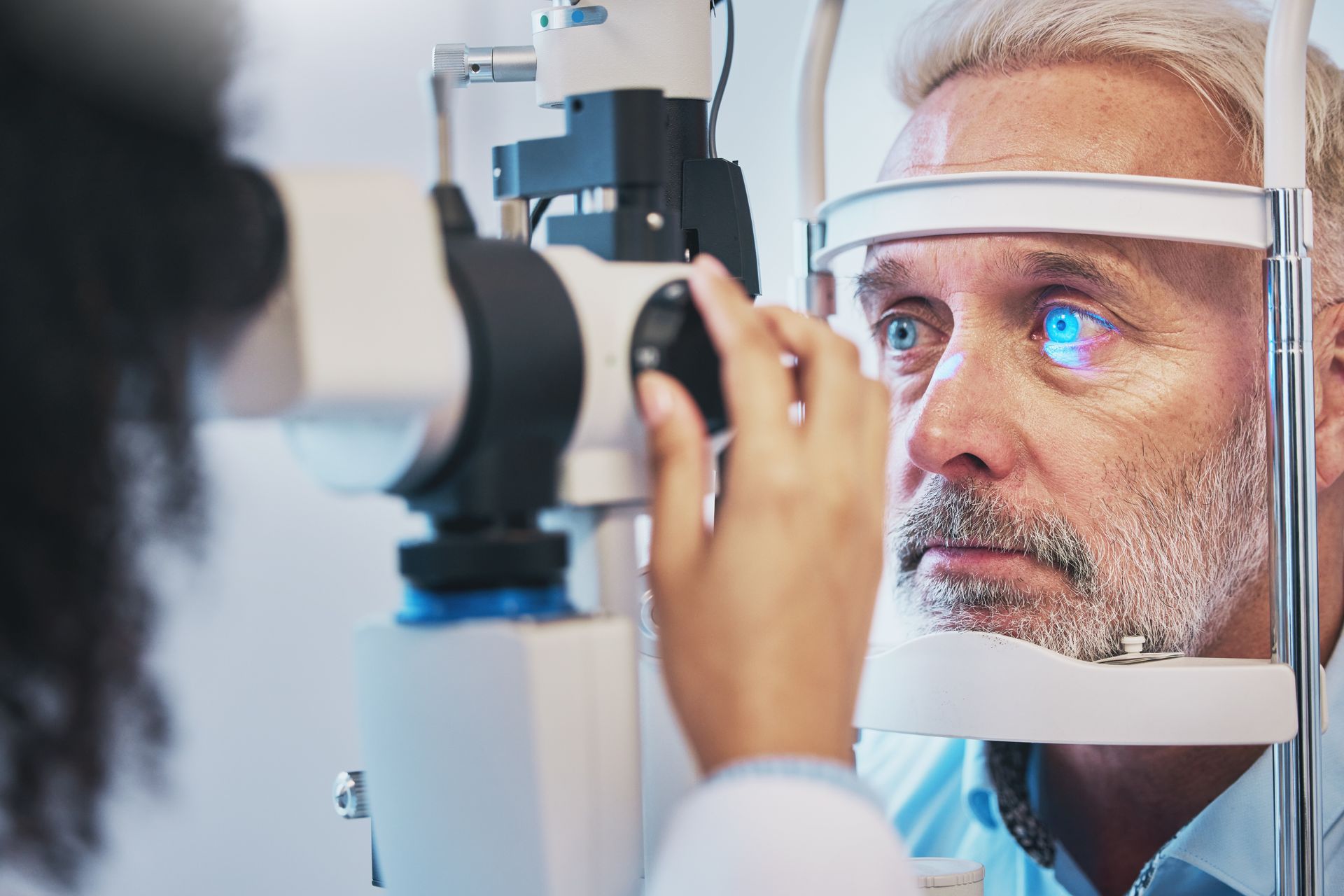 A man is getting his eyes examined by an ophthalmologist.