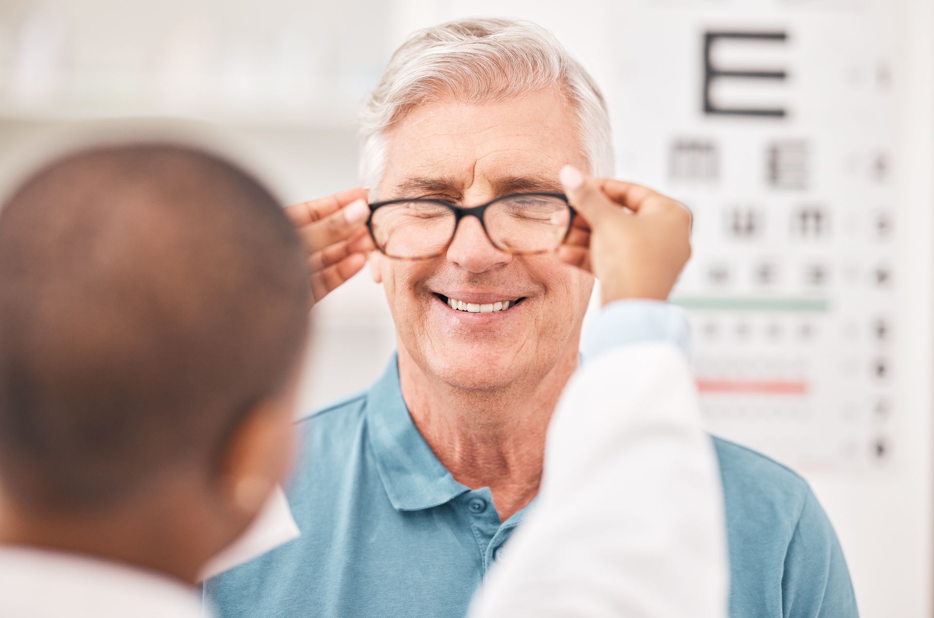 An older man is getting his eyes checked by an ophthalmologist.