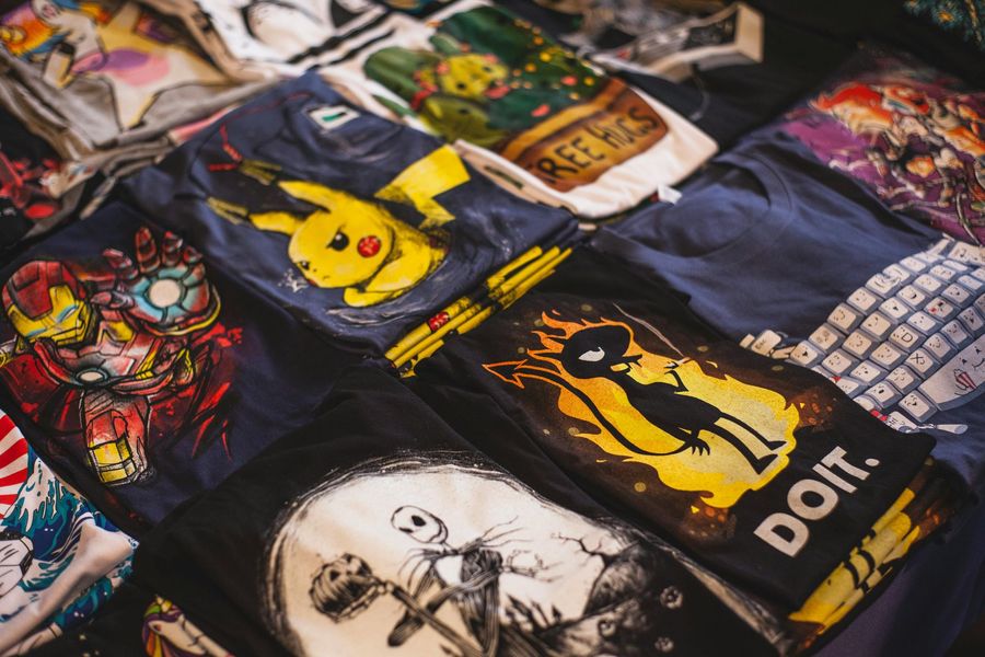 T-shirts with various cartoon and character designs, including Pikachu, Iron Man, and Jack Skellington.