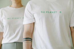 Two people in white t-shirts with the phrase 