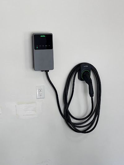 A charger for an electric car is attached to a wall.