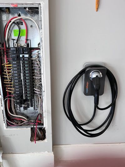 A man is cutting a wire with a pair of pliers.