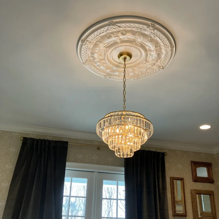 A chandelier is hanging from the ceiling in a room