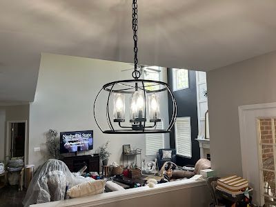 A chandelier is hanging from the ceiling in a living room.