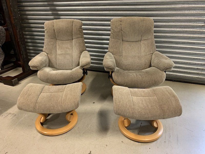 A Pair of Upholstered Ekornes Reclining Armchairs &  Footstools
