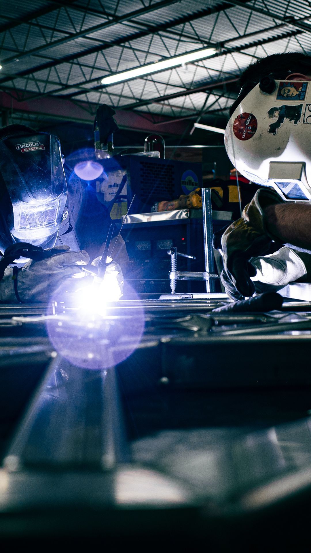 Integrus Team members welding custom metalwork together