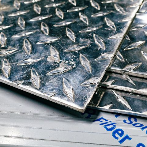 A sheet of metal is sitting on top of a table in the Integrus Fabrication shop.