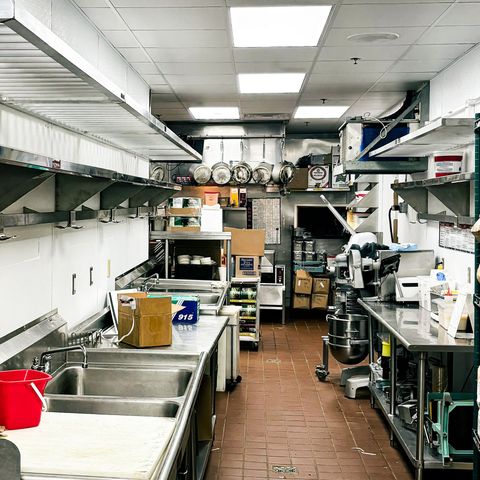 A kitchen with stainless steel appliances and a sink.