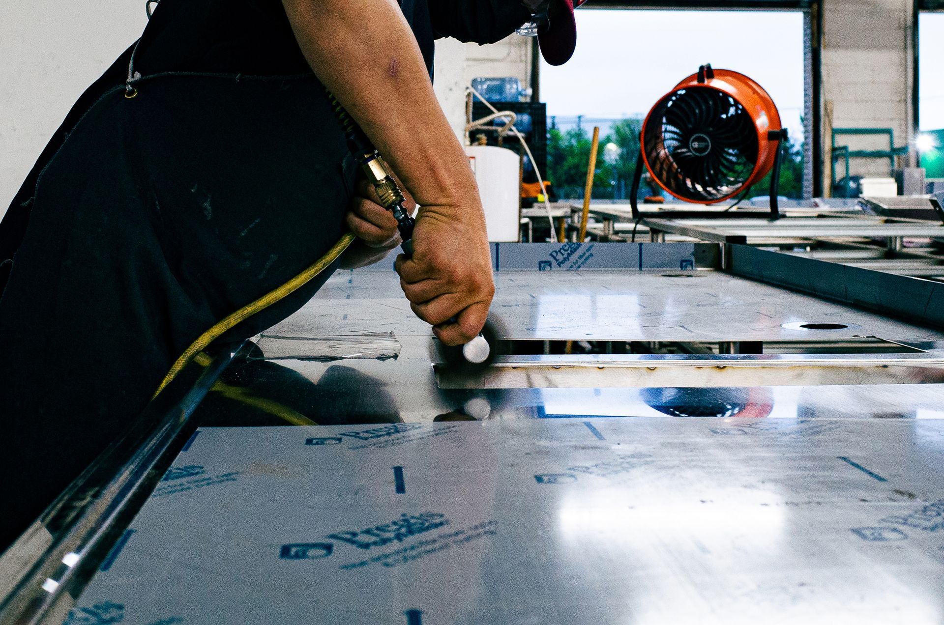 Integrus Fabrication Team Member Polishing Food Service Equipment