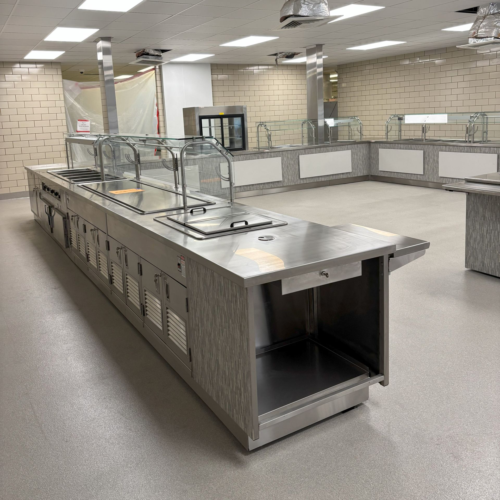 A kitchen with stainless steel appliances and a sink.