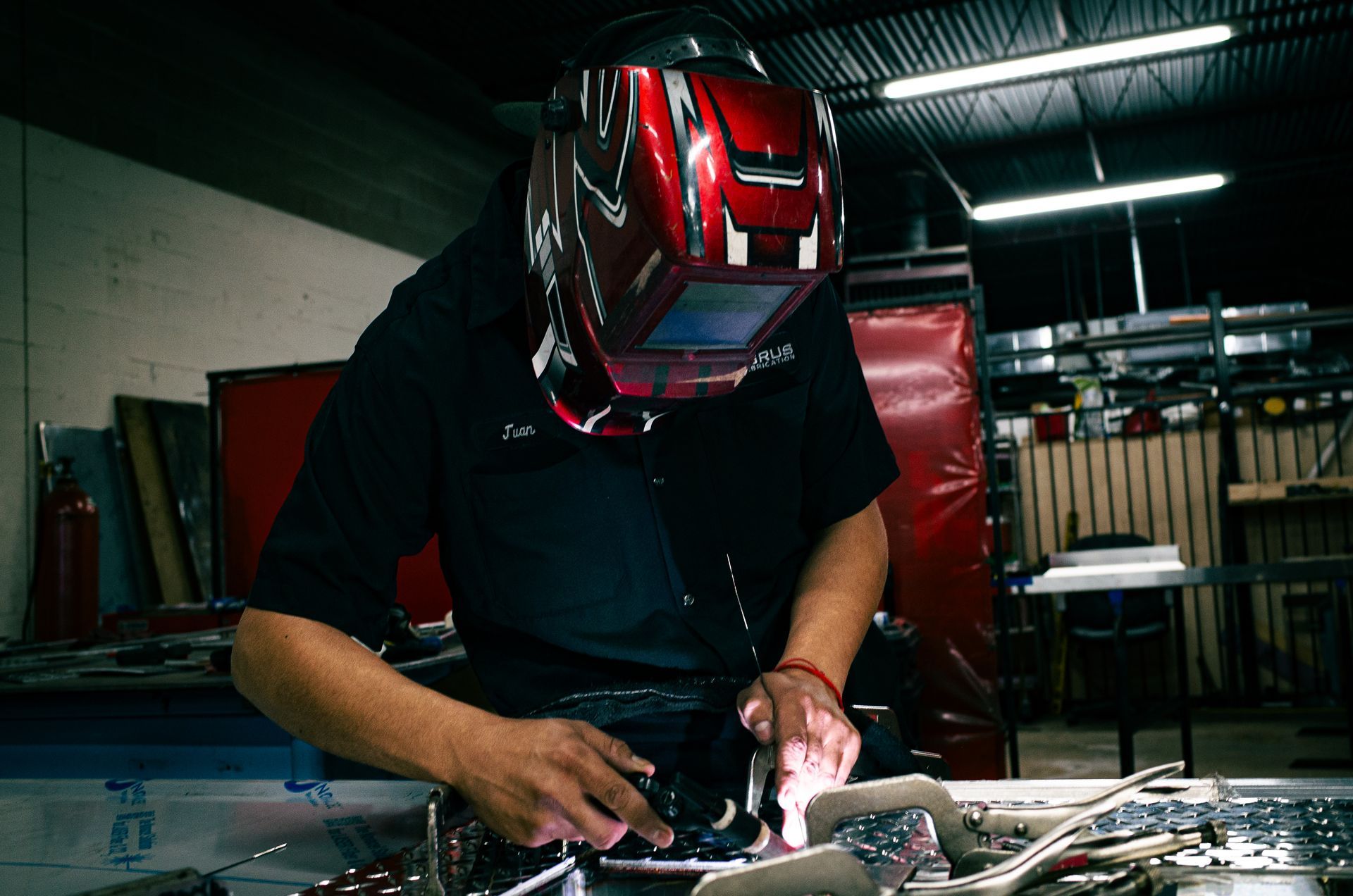 Integrus Team member welding metal fabricated equipment.