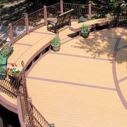 Wooden deck with curved edges, brown trim, bench, and potted plants.