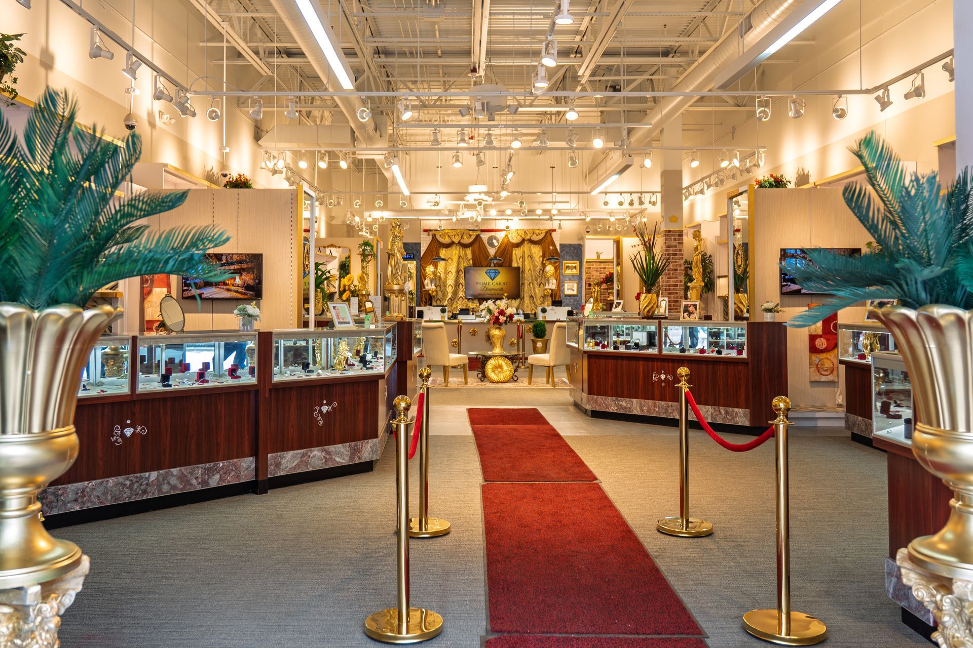 Interior of a jewelry store, showcasing display cases, artwork, and a red carpet path.