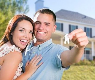 Homeowners Insurance Agency — Couple Holding a House Key in Burlington, NJ