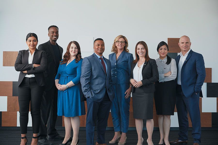 A group of business people are posing for a picture together.