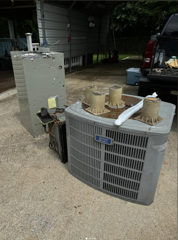 Old air conditioning units, grey metal, outside on concrete.