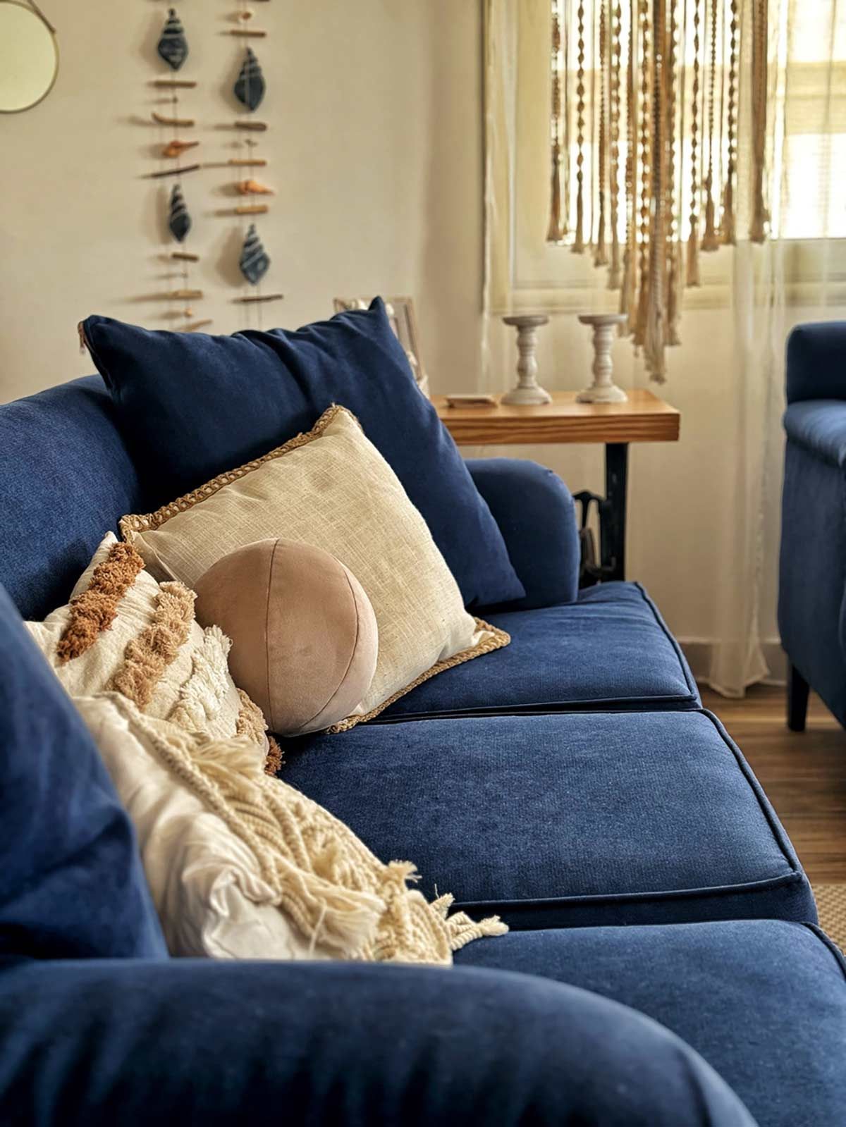 A blue couch with pillows on it in a living room