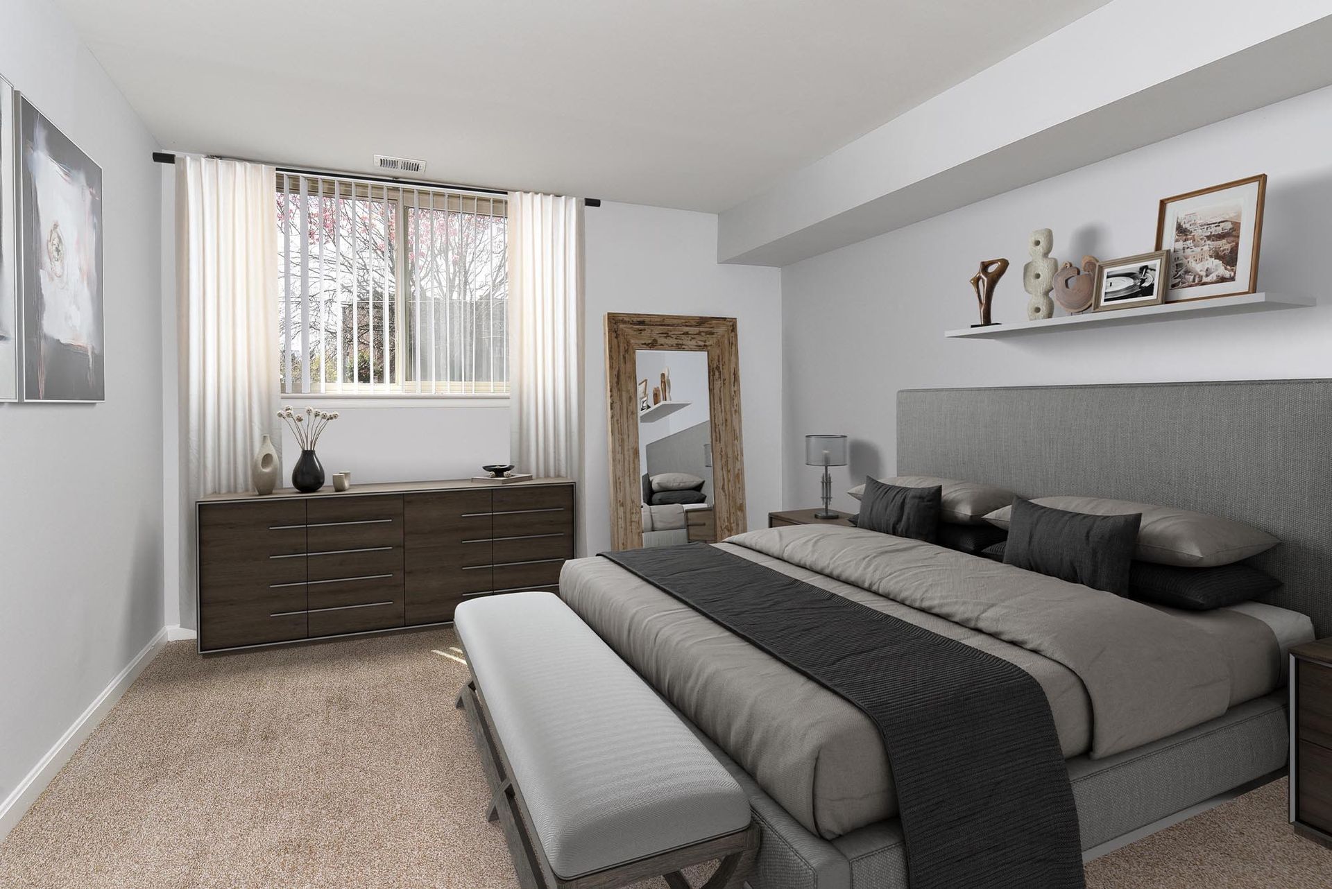 Bedroom interior with a bed, dresser, mirror, window with curtains, and neutral-colored carpet at Glenmont Station in Silver Spring, MD.