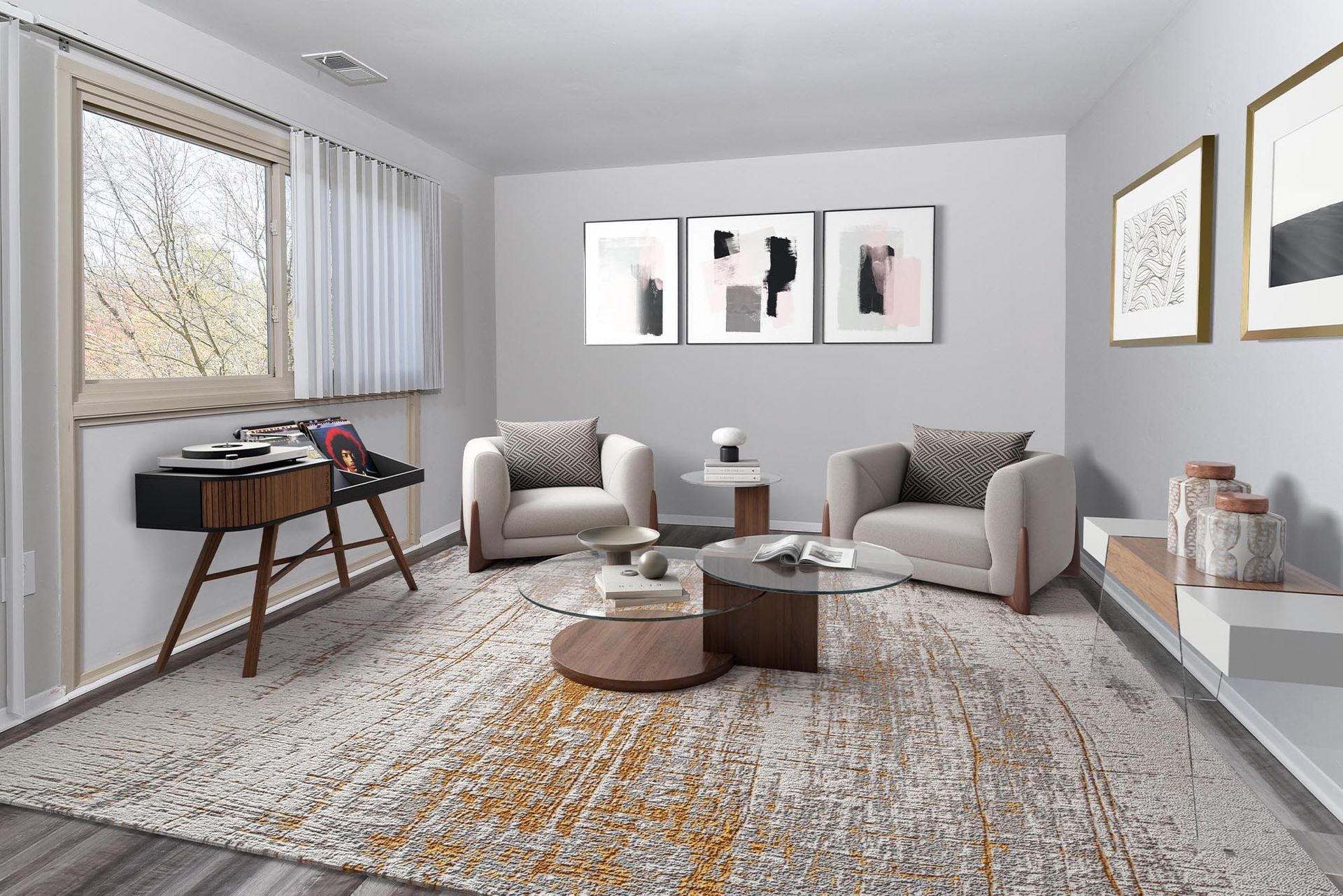 Living room with two armchairs, a rug, a coffee table, and abstract art on the wall at Glenmont Station in Silver Spring, MD.