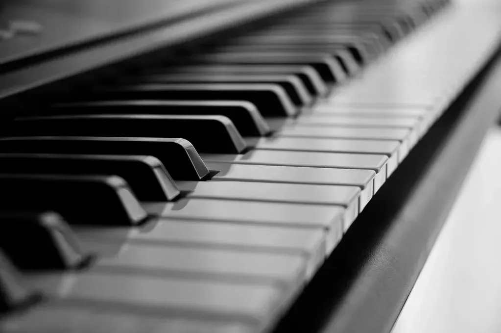 A black and white photo of a piano keyboard.